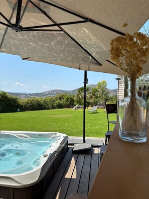 A hot tub under a canopy with a view of a grassy yard and hills. - PROMO VILLA NEAR AJACCIO WITH SPA, NEAR BEACHES 5 MIN, 14 PEOPLE / 2 BATHROOM (Afa)
