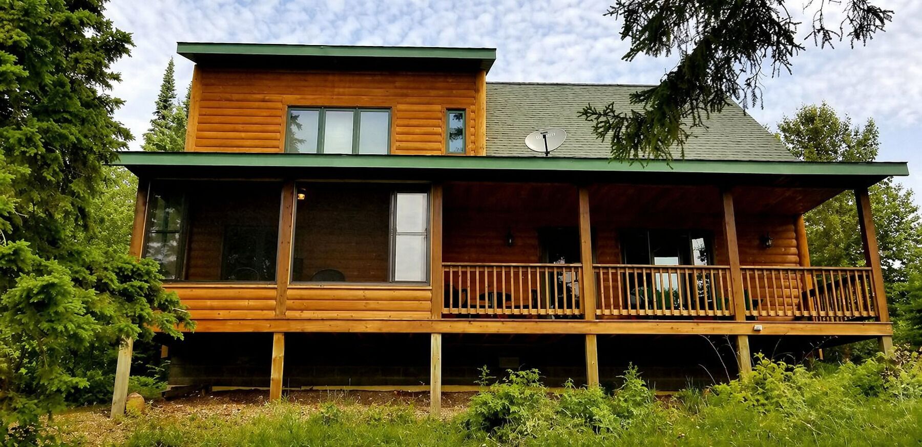 East-facing covered deck and 3-season porch offer sunrise and forest views