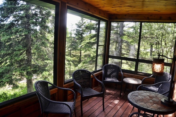 Fabulous 3 season porch! Windows open to 75% screen for air flow & wooded views.