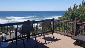 A wooden deck with two chairs and a small table, overlooking the ocean. - 180 degree ocean beach view. Depoe Bay Lincoln beach area.
quick walk to beach 
 (Lincoln Beach)