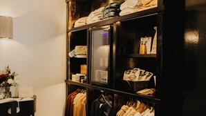 A walk-in closet with shelves, hanging space, and a vanity area. - The Brooks Hotel (Wallace)