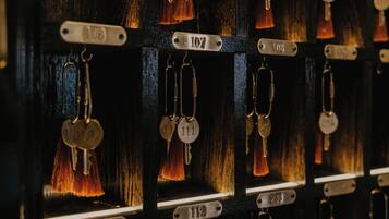 A close-up of a key rack with numbered keys and tags, indicating a secure storage system for guests' keys.