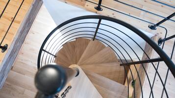 A spiral staircase with wooden steps and metal railings.