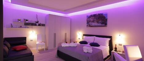 Deluxe Suite, Sea View | Minibar, in-room safe, desk, blackout drapes