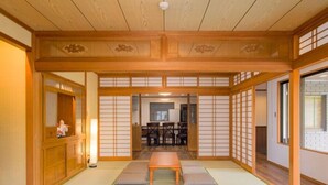 Een traditionele Japanse kamer met tatami vloeren, een lage tafel en verschuifbare deuren.