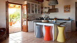 A kitchen with white cabinets, a wooden ceiling, and a large window. - Luxury Private Villa with 15mx6m Pool. Private Setting with Panoramic views (orturano, bagnone)