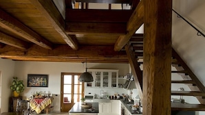 A spacious kitchen with white cabinets and a wooden staircase. - Luxury Private Villa with 15mx6m Pool. Private Setting with Panoramic views (orturano, bagnone)