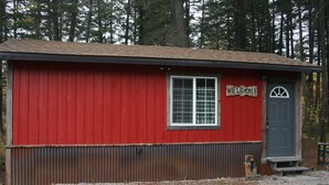 A red building with a 'WELCOME' sign, a window, and a door. - Tiny Red Farmhouse centrally located in Columbia Falls (Columbia Falls)