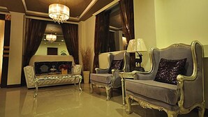 A luxurious living room with a sofa set, a chandelier, and a large window with curtains. - The Colors Under The Sea (Hengchun)