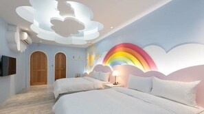 A bedroom with two beds, a TV, and a wall mural of clouds and a rainbow. - Seed House (Taitung)