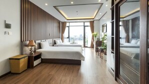 A modern hotel room with two beds, a large window, and a view of the city. - Hello Hotel (Vo Cuong)