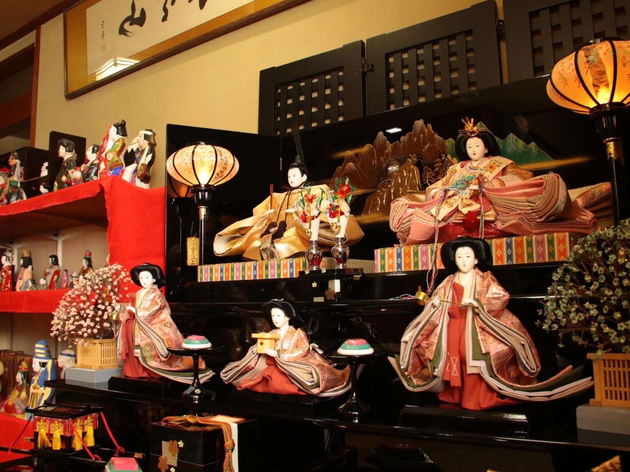 A traditional Japanese room with tatami flooring, a low table, and a hanging scroll on the wall.