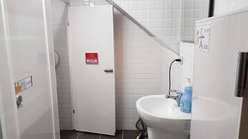 Shower, hair dryer, slippers, towels