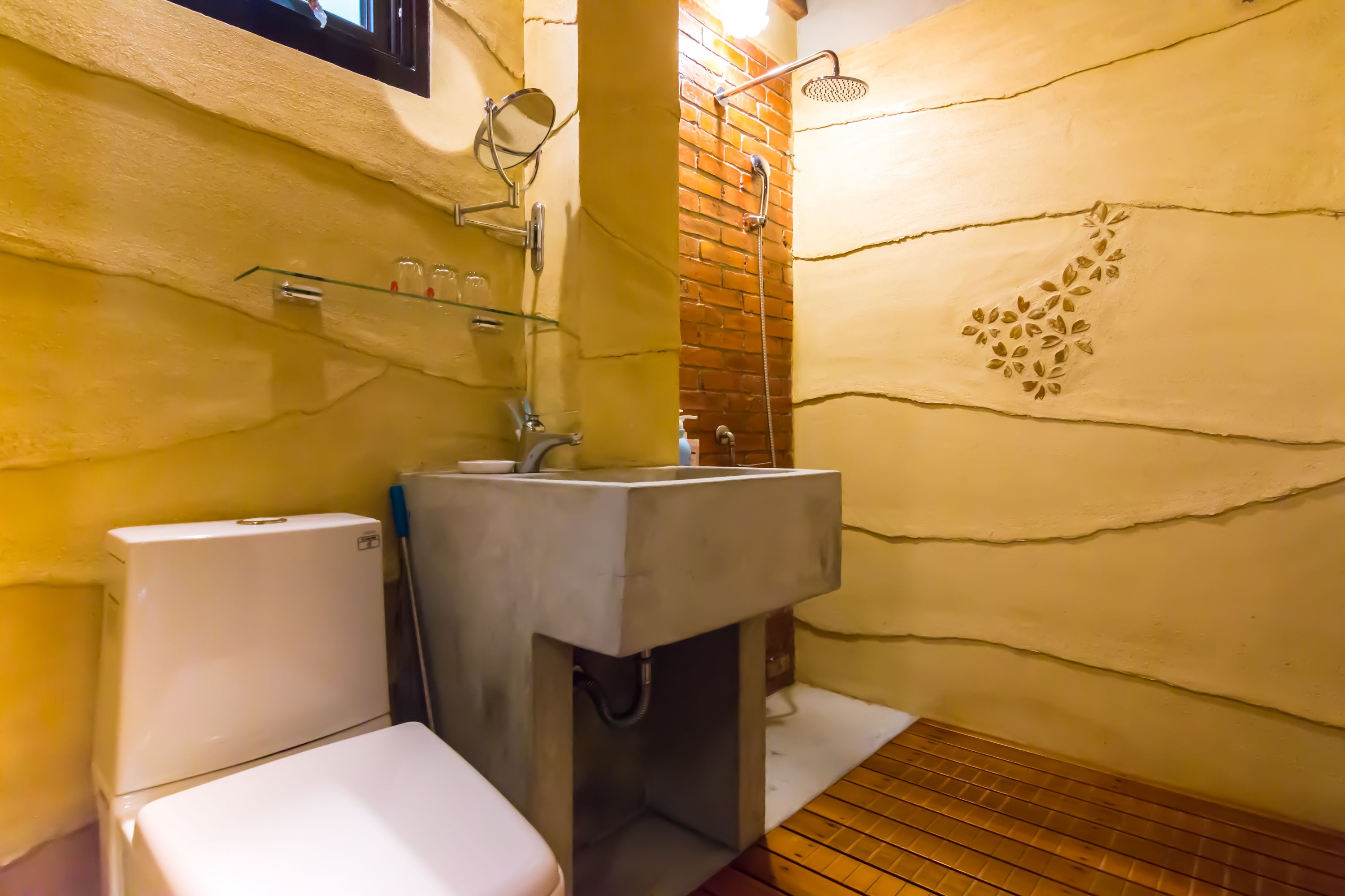 A bathroom with a toilet, a sink, and a shower.
