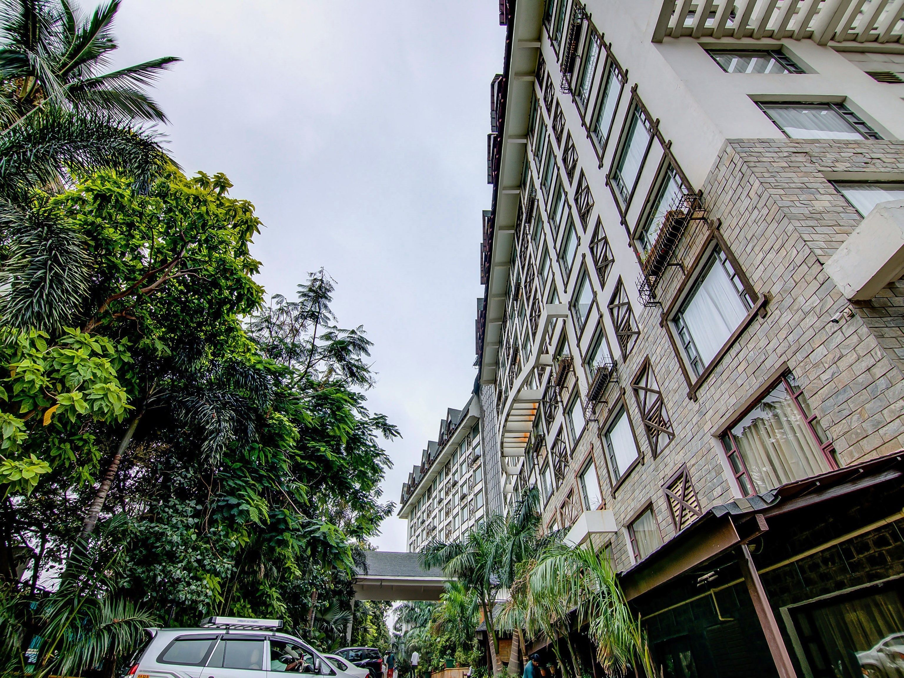 A multi-story building with a modern architectural design, featuring a mix of brick and glass facades.