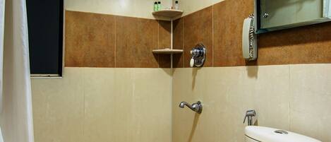 A bathroom with a shower, toilet, and a towel rack.