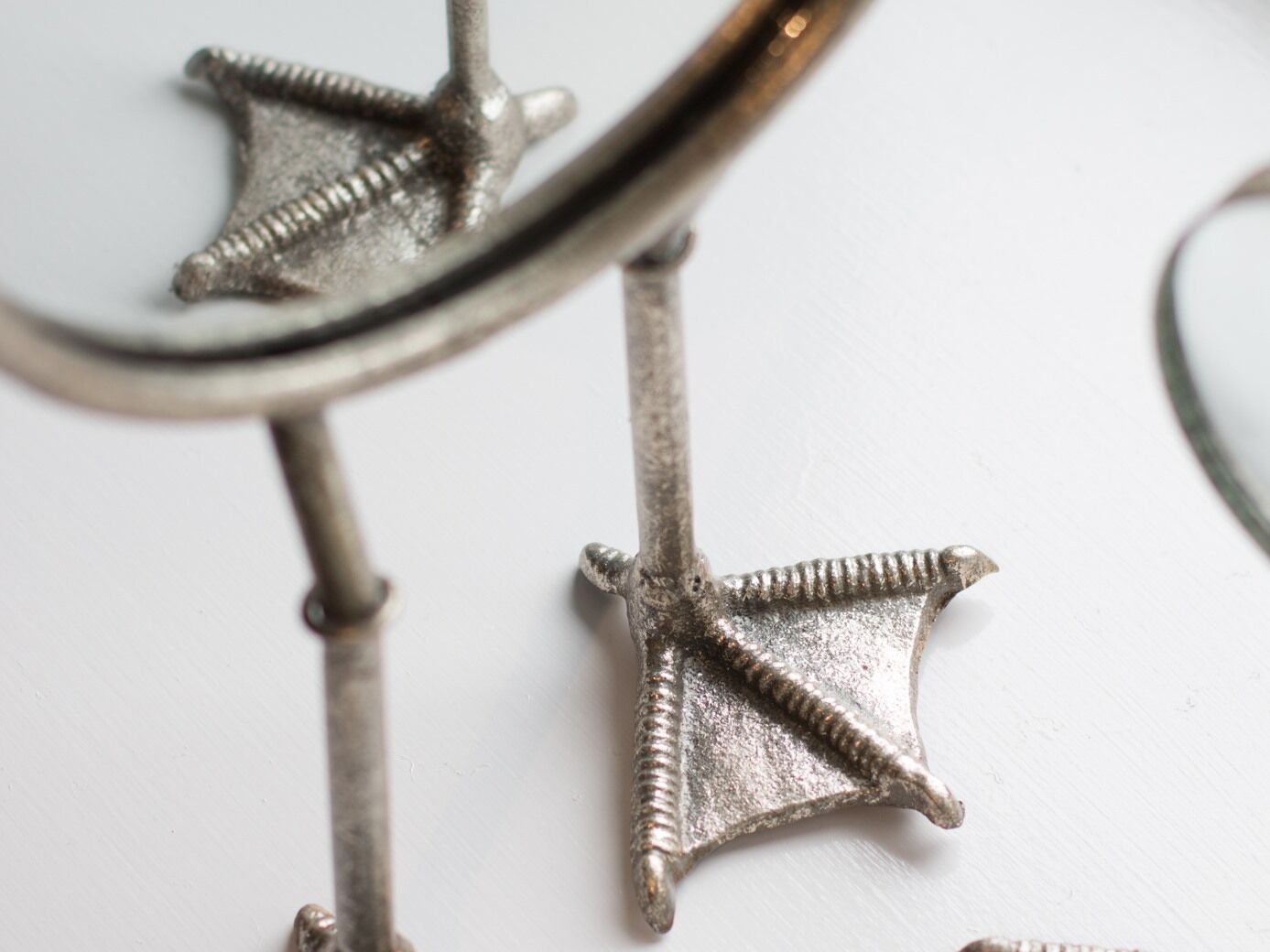 A close-up of a metallic object with star-shaped elements and a screw.