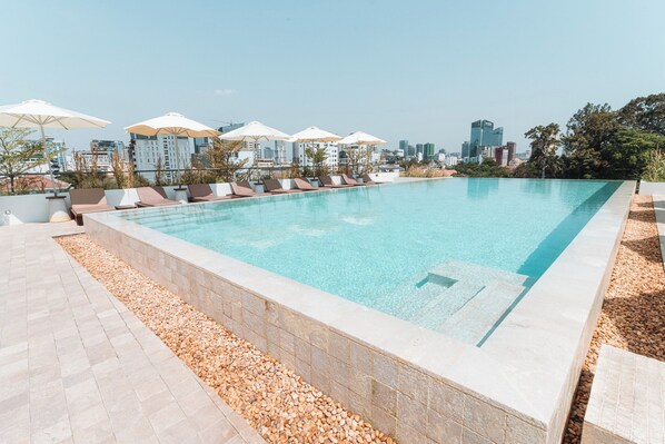 Outdoor pool, open 7:00 AM to 10:00 PM, pool umbrellas