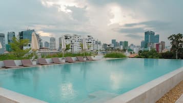 Outdoor pool, open 7:00 AM to 10:00 PM, pool umbrellas