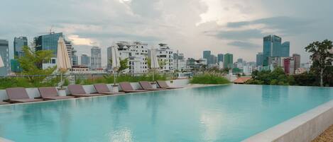 Outdoor pool, open 7:00 AM to 10:00 PM, pool umbrellas