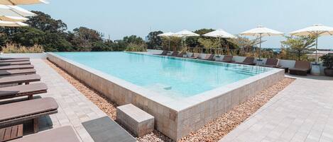 Outdoor pool, open 7:00 AM to 10:00 PM, pool umbrellas