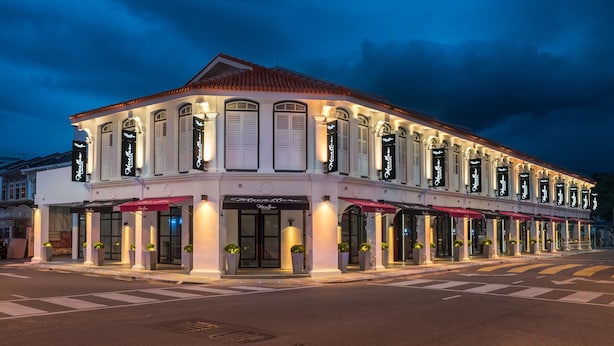 A two-story hotel with a classic facade, large windows, and a red awning. - Macallum Central Hotel Managed By The Ascott Limited (George Town)
