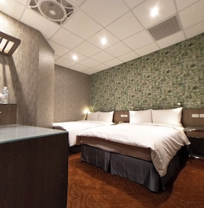 A hotel room with two beds, a desk, and a patterned wall. - Ueno Hirokoji 428 (Taipei)