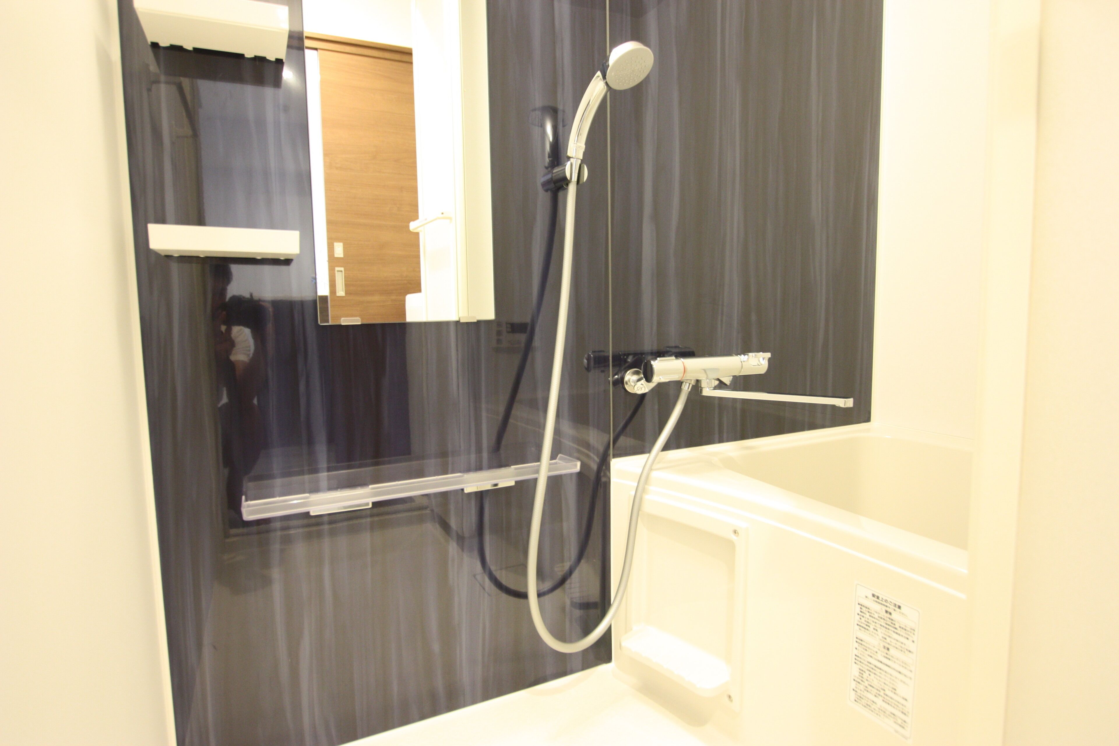 A bathroom with a shower, a toilet, and a sink.