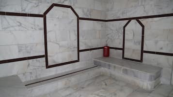 Bathroom features a bench and decorative wall pattern.