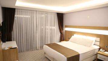 Standard Twin Room | Minibar, in-room safe, desk, iron/ironing board