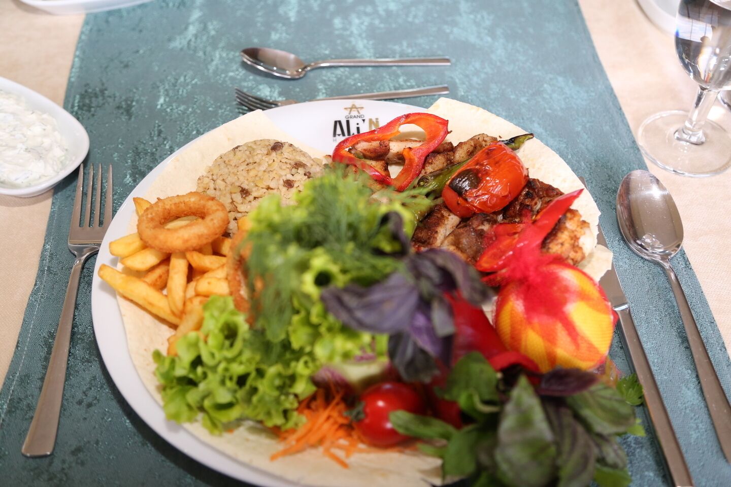 A plate of food with grilled vegetables, a salad, and fried items.