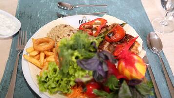A plate of food with grilled vegetables, a salad, and fried items.