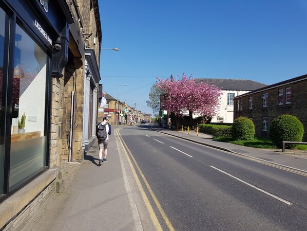 A street with a pedestrian walking on the sidewalk. - The Retreat (Huddersfield)