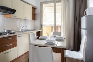 Apartment, 1 Bedroom, Balcony | Private kitchen | Full-size fridge, microwave, stovetop, cookware/dishes/utensils - Residence Queen (Rimini)