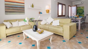 Basic Double Room, 1 Bedroom | Living area | Flat-screen TV