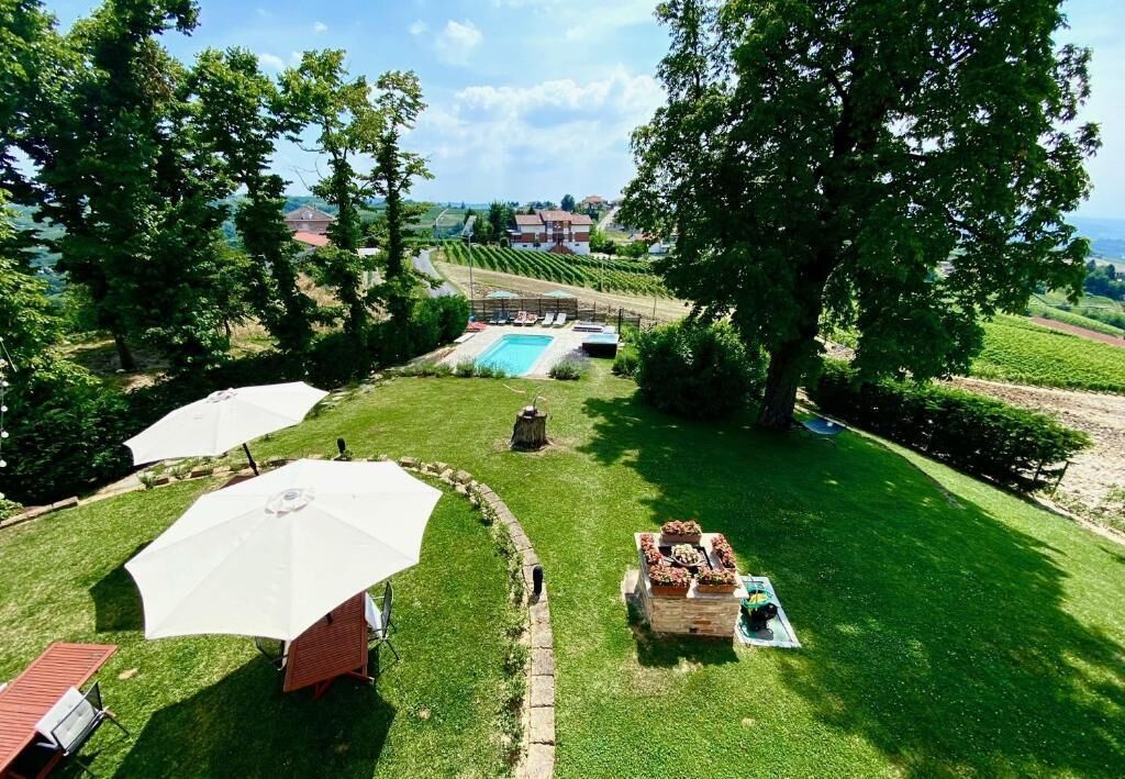 A well-maintained outdoor area with a swimming pool, umbrellas, and a seating area.