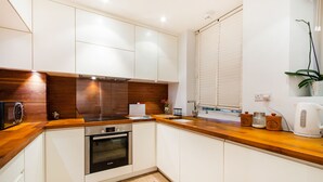 Exclusive Apartment, 2 Bedrooms | Private kitchen | Coffee/tea maker, full-sized fridge, microwave, oven
