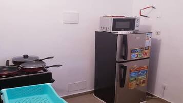Suite estudio Confort | Cocina privada | Refrigerador, microondas, horno y parrilla de estufa