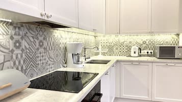 Grand Apartment, 1 Bedroom, Bathtub, City View | Private kitchen | Fridge, microwave, stovetop, coffee/tea maker