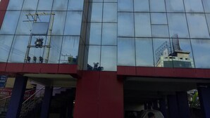 A modern hotel building with a prominent sign for "Hotel Grand Luit" and "Indian Overseas Bank" at the top. - Hotel Grand Luit (Guwahati)