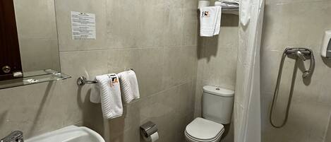 A bathroom with a sink, toilet, and shower.