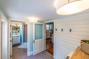A laundry room with a sign, a sink, and a mirror. - Coastal Charmer, Fire Pit & Two Blocks to Beach (Cape Charles)