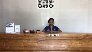 A reception desk with a wooden surface and a sign labeled "OFFICE".