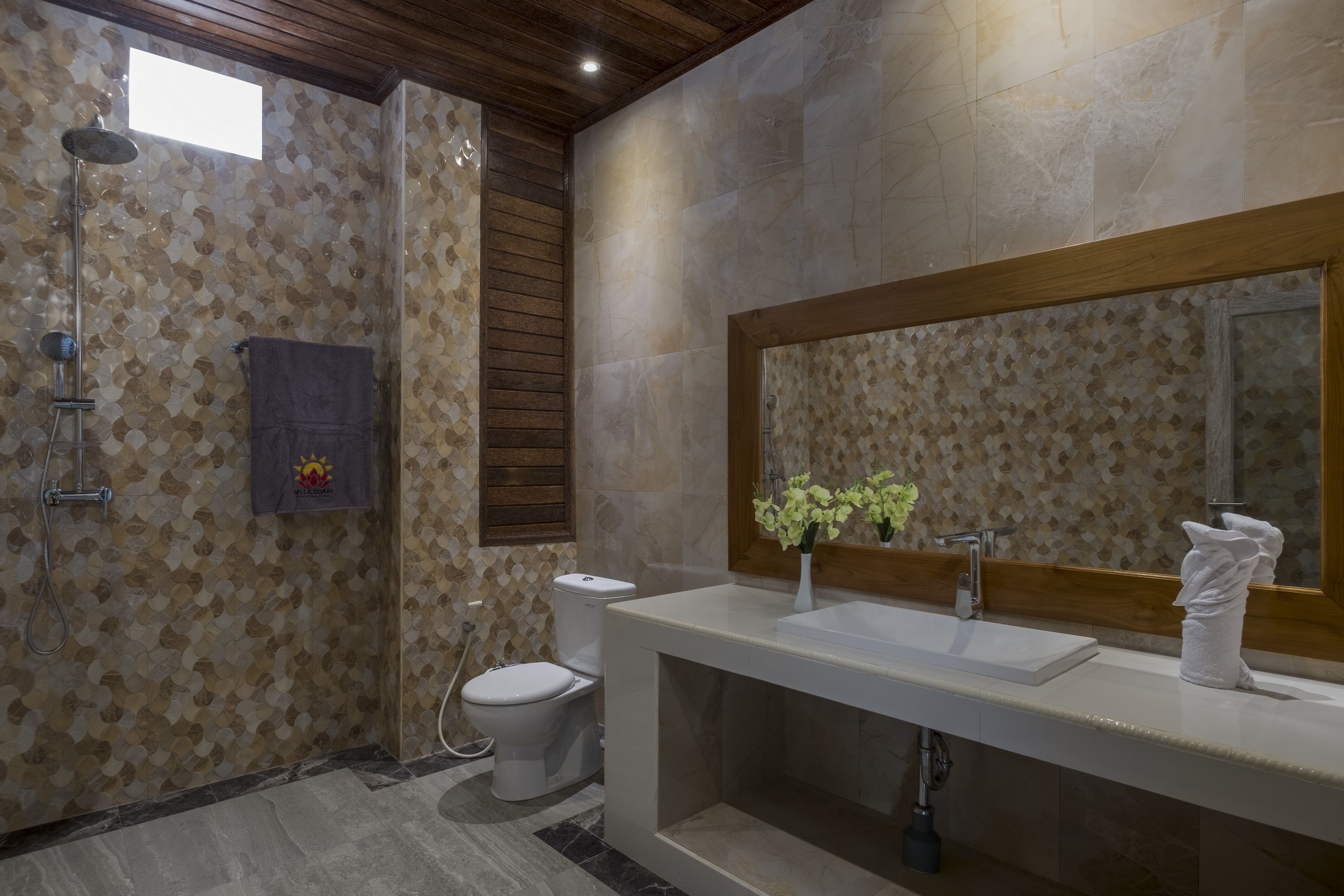 A modern bathroom with a shower, toilet, and sink.