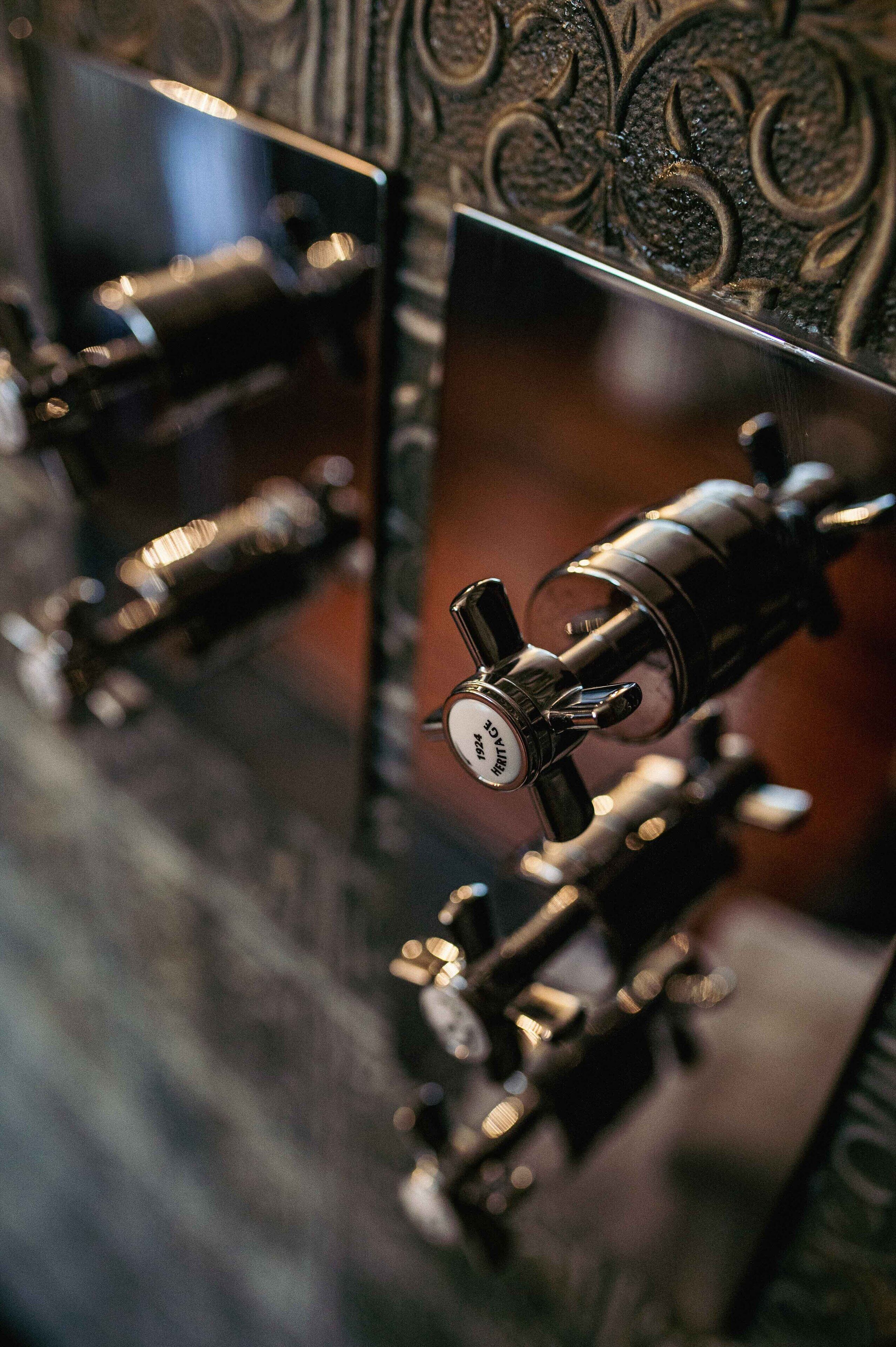 A close-up of a mechanical device with a dial and a lever, possibly a part of a machine or equipment.