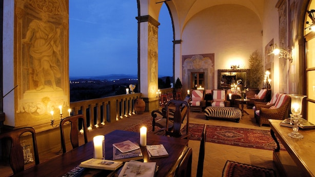 A grand room with a high ceiling, ornate columns, and a balcony overlooking a scenic view. - Villa Mangiacane (San Casciano)