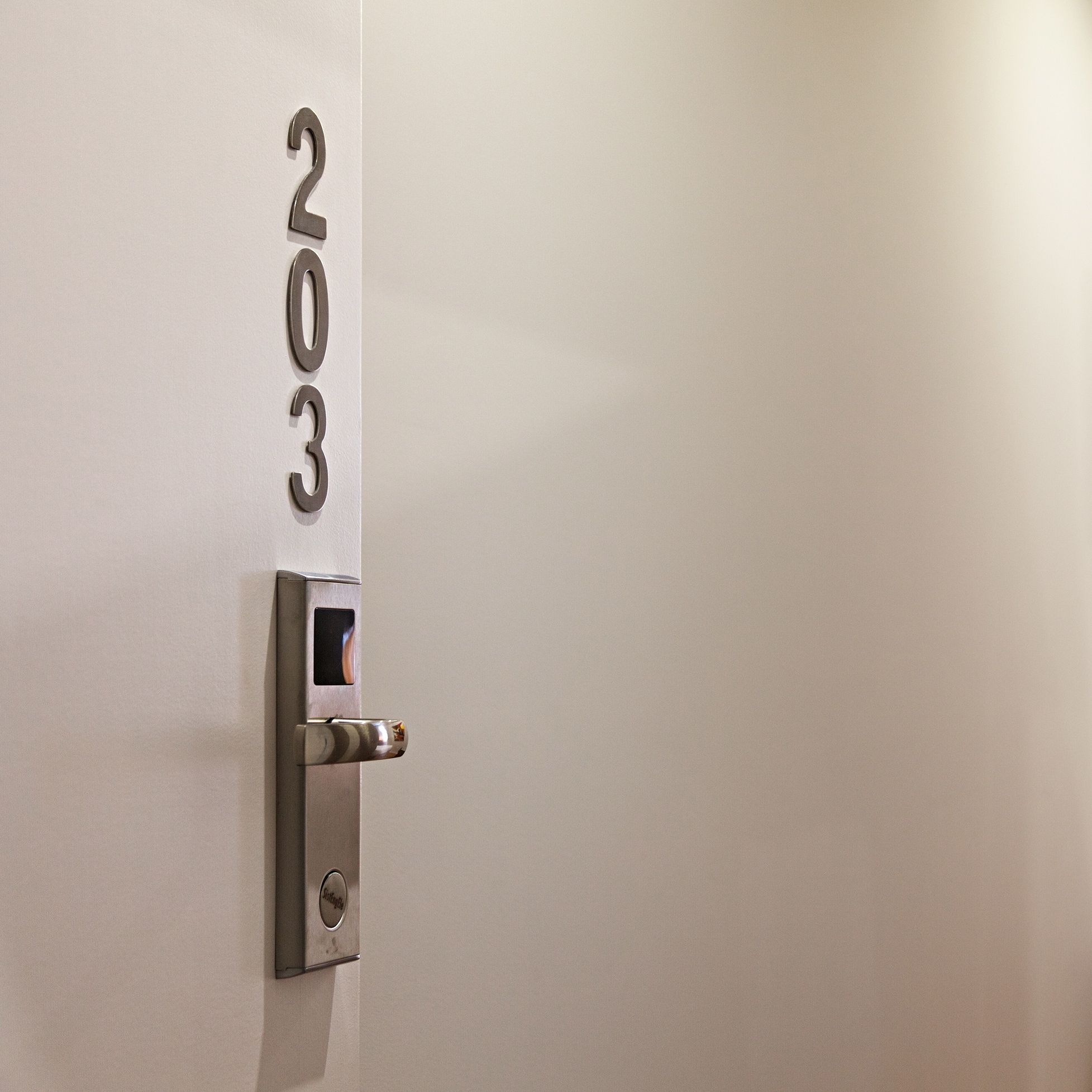 A door with a numeric keypad and a lock, indicating a secure entry point.
