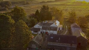 An aerial view of a rural area with houses, a road, and a field. - Lane Head Farm Country Guest House (Penrith)