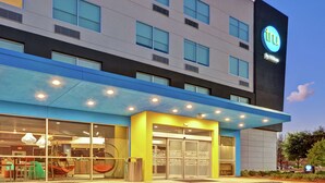 A modern hotel with a blue and grey facade, large windows, and a prominent 'try by Hilton' sign. - Tru by Hilton Baton Rouge Citiplace, LA (Baton Rouge)