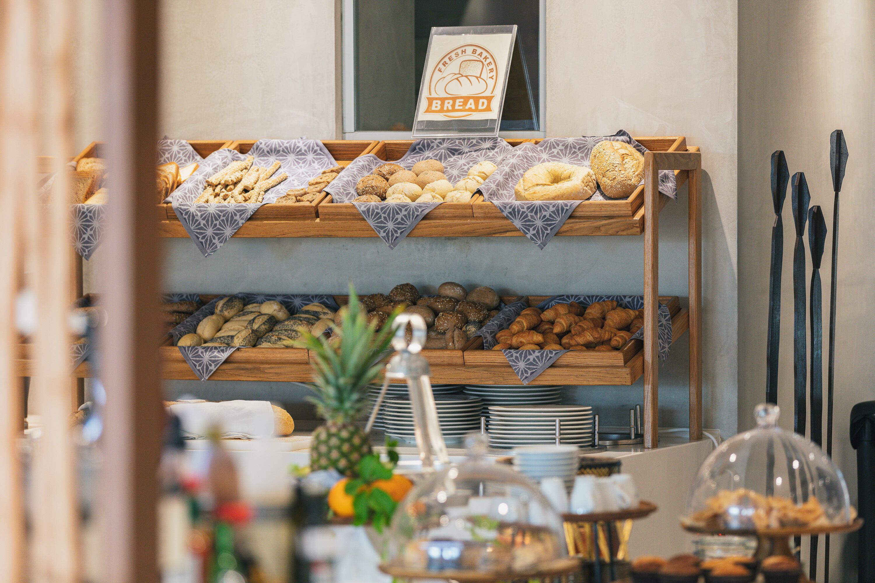 A bakery display with various breads and pastries.